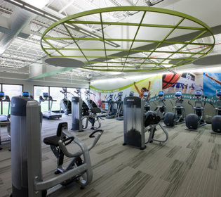 a gym with exercise equipment in the center of the room